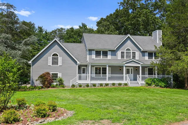 a front view of a house with a garden and plants