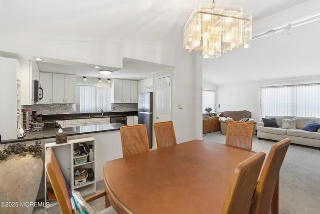 a large kitchen with a table chairs stove and refrigerator
