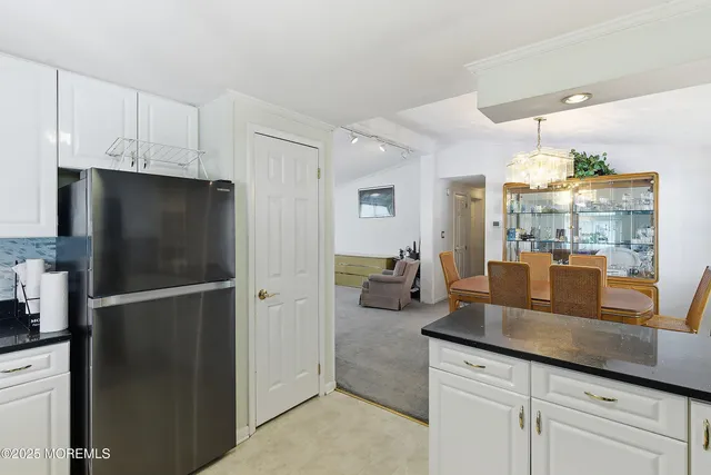 a kitchen with refrigerator and cabinets