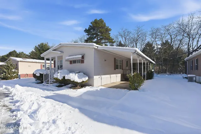 a view of a house with a snow in the yard