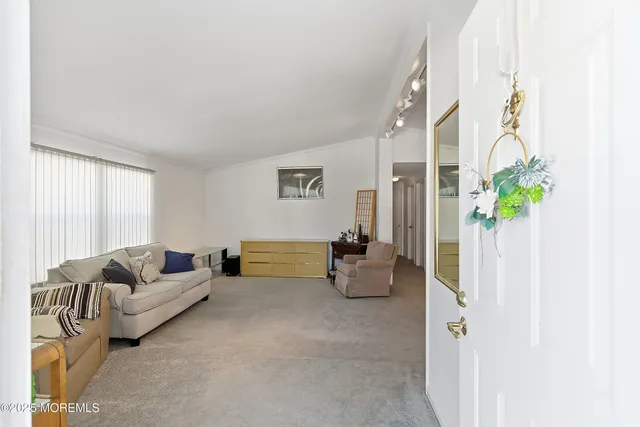 a living room with furniture and flowers