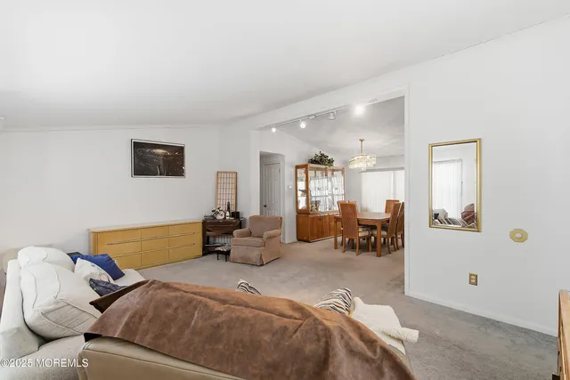 a bedroom with furniture and a large window