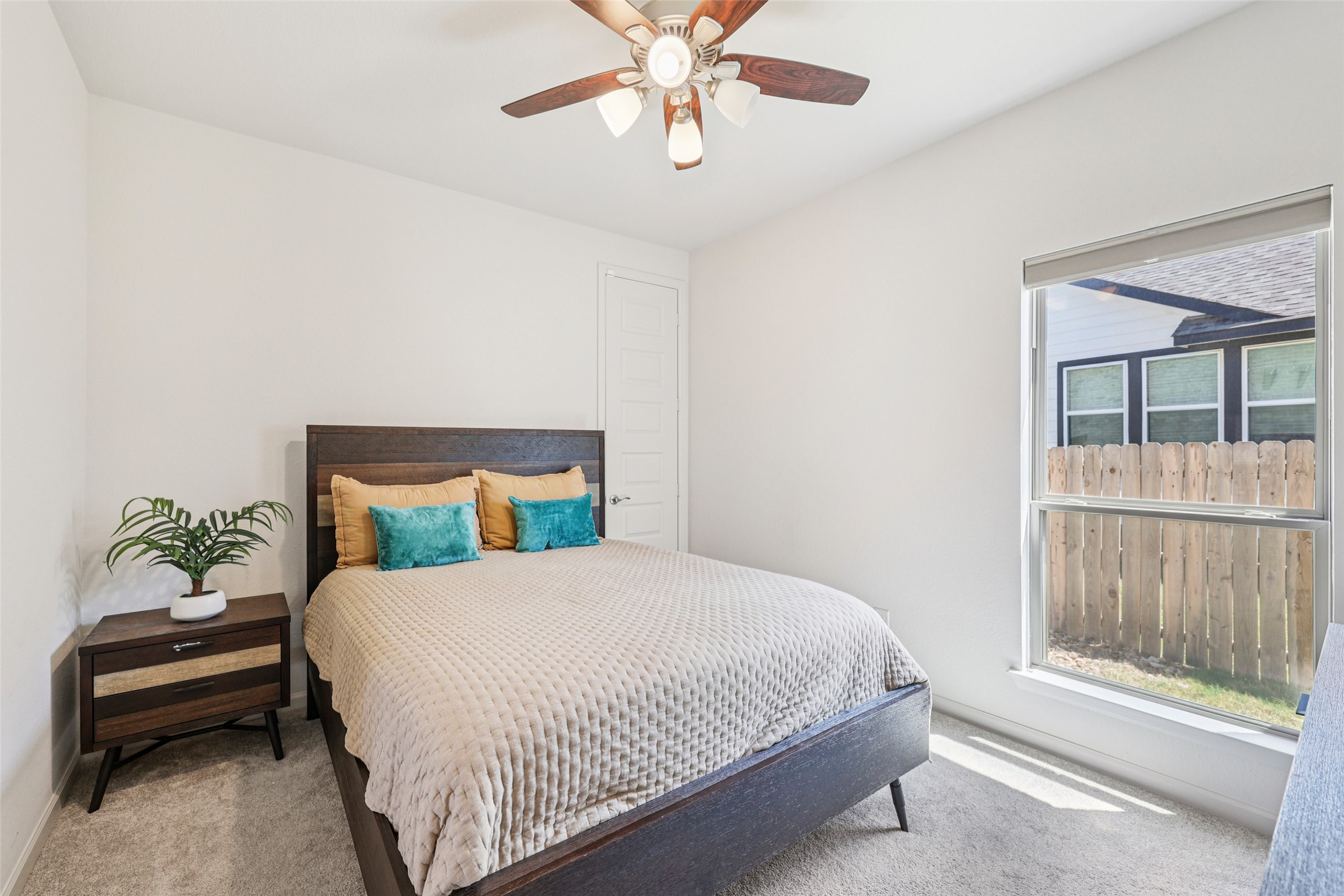 1140 Bryson Rdg Trail Leander, TX 78641 - Photo 22 of 39 This room features light-colored walls and carpet, a window with natural light, and a ceiling fan with integrated lighting