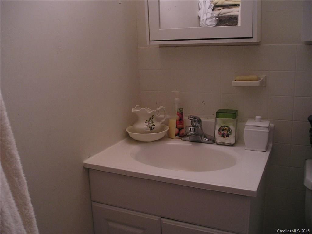 4904 Morgan Mill Road Monroe, NC 28110 - Photo 14 of 24 a bathroom with a sink and a mirror