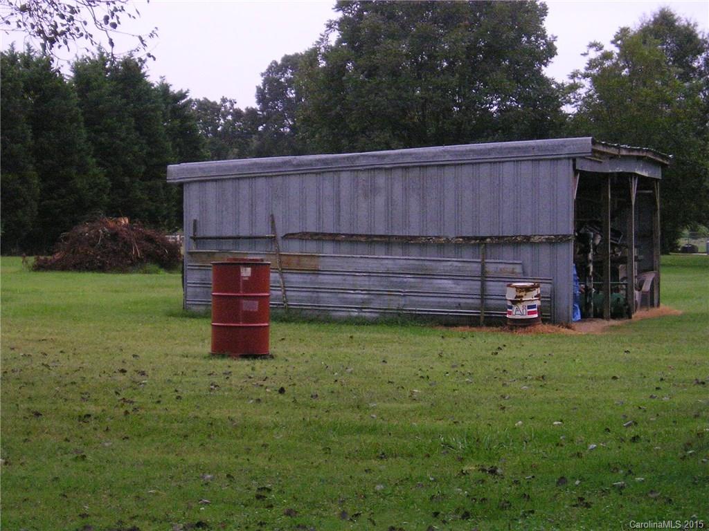 4904 Morgan Mill Road Monroe, NC 28110 - Photo 22 of 24 a view of a backyard with barn and large trees