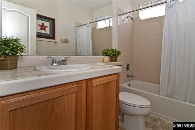 475 Cicada Court Reno, NV 89521 - Photo 11 of 13 a bathroom with a sink a toilet and shower