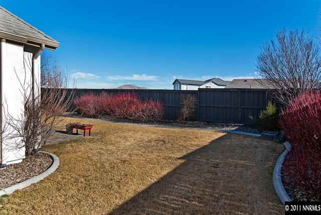 475 Cicada Court Reno, NV 89521 - Photo 12 of 13 a view of a backyard with plants and a barbeque