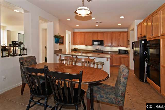 475 Cicada Court Reno, NV 89521 - Photo 4 of 13 a large kitchen with a dining table chairs stainless steel appliances and cabinets