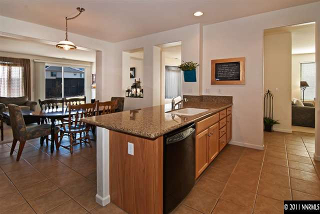 475 Cicada Court Reno, NV 89521 - Photo 5 of 13 a kitchen with stainless steel appliances granite countertop a sink and a refrigerator