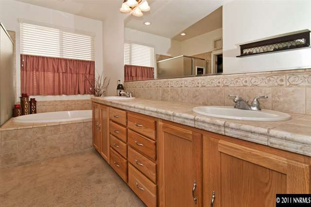 475 Cicada Court Reno, NV 89521 - Photo 9 of 13 a spacious bathroom with a granite countertop sink mirror and a bathtub