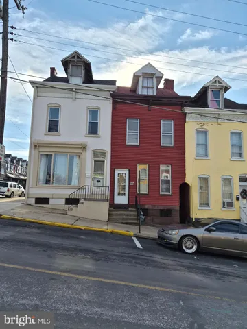 a view of a brick house with many windows