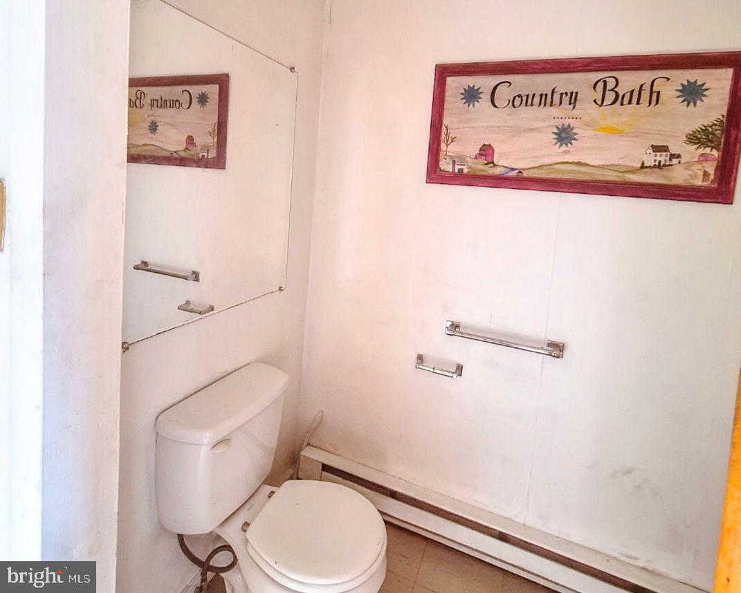 1262 Buttonwood Street Reading, PA 19604 - Photo 19 of 22 a white toilet sitting next to a shower