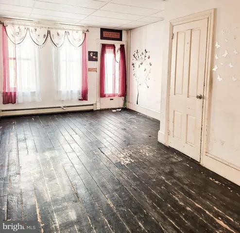 a view of a closet area with wooden floor