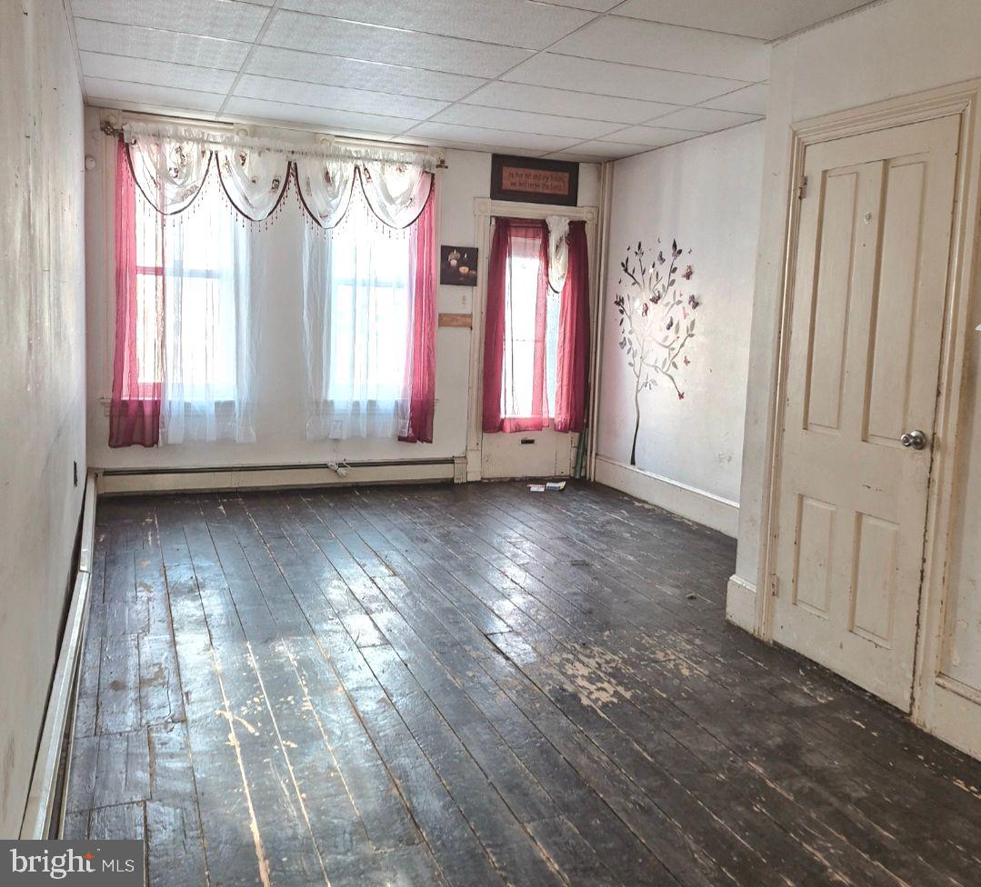 1262 Buttonwood Street Reading, PA 19604 - Photo 4 of 22 wooden floor in an empty room with a window