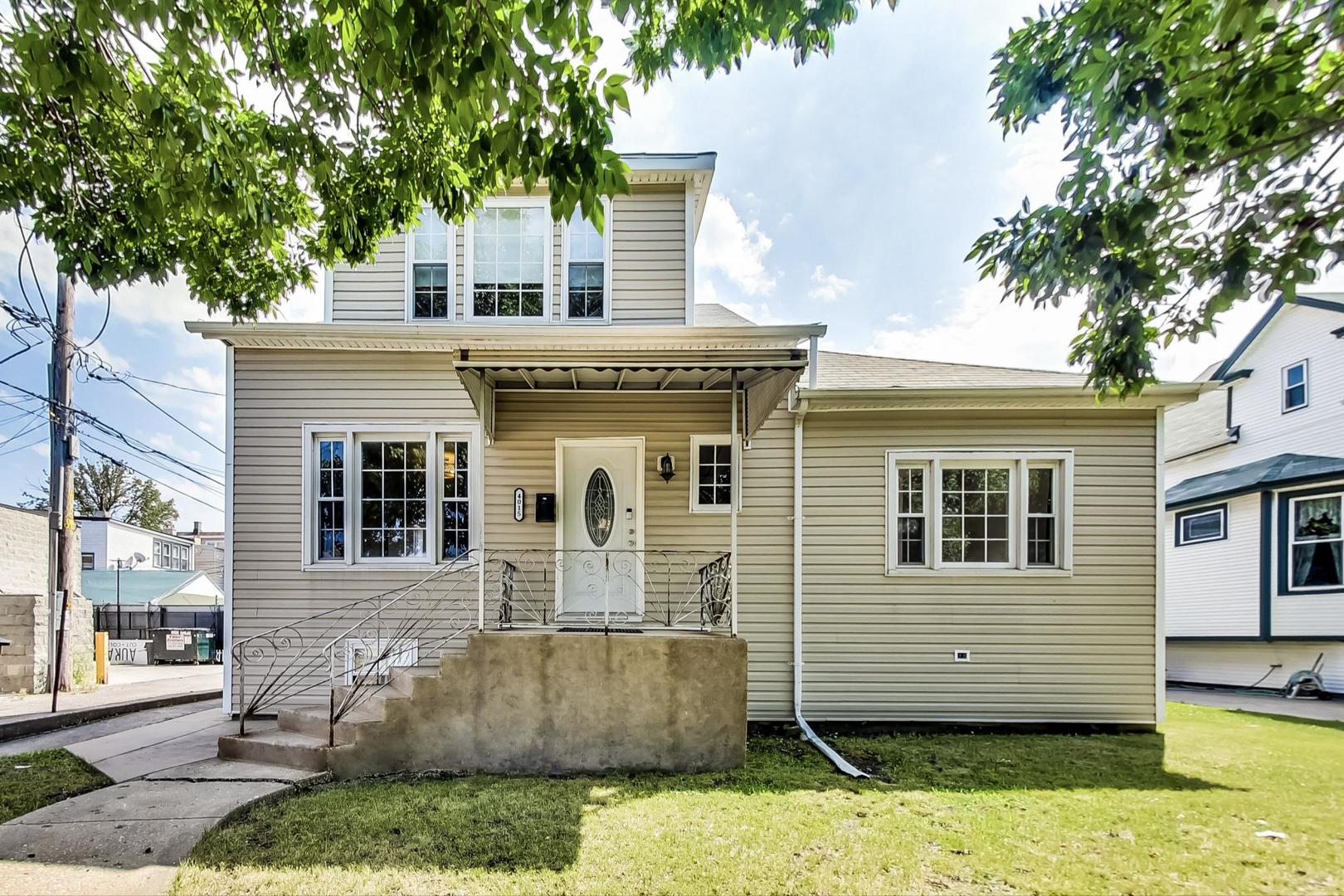 4015 West Addison Street Chicago, IL 60641 - Photo 1 of 30 a front view of a house with a yard and garage
