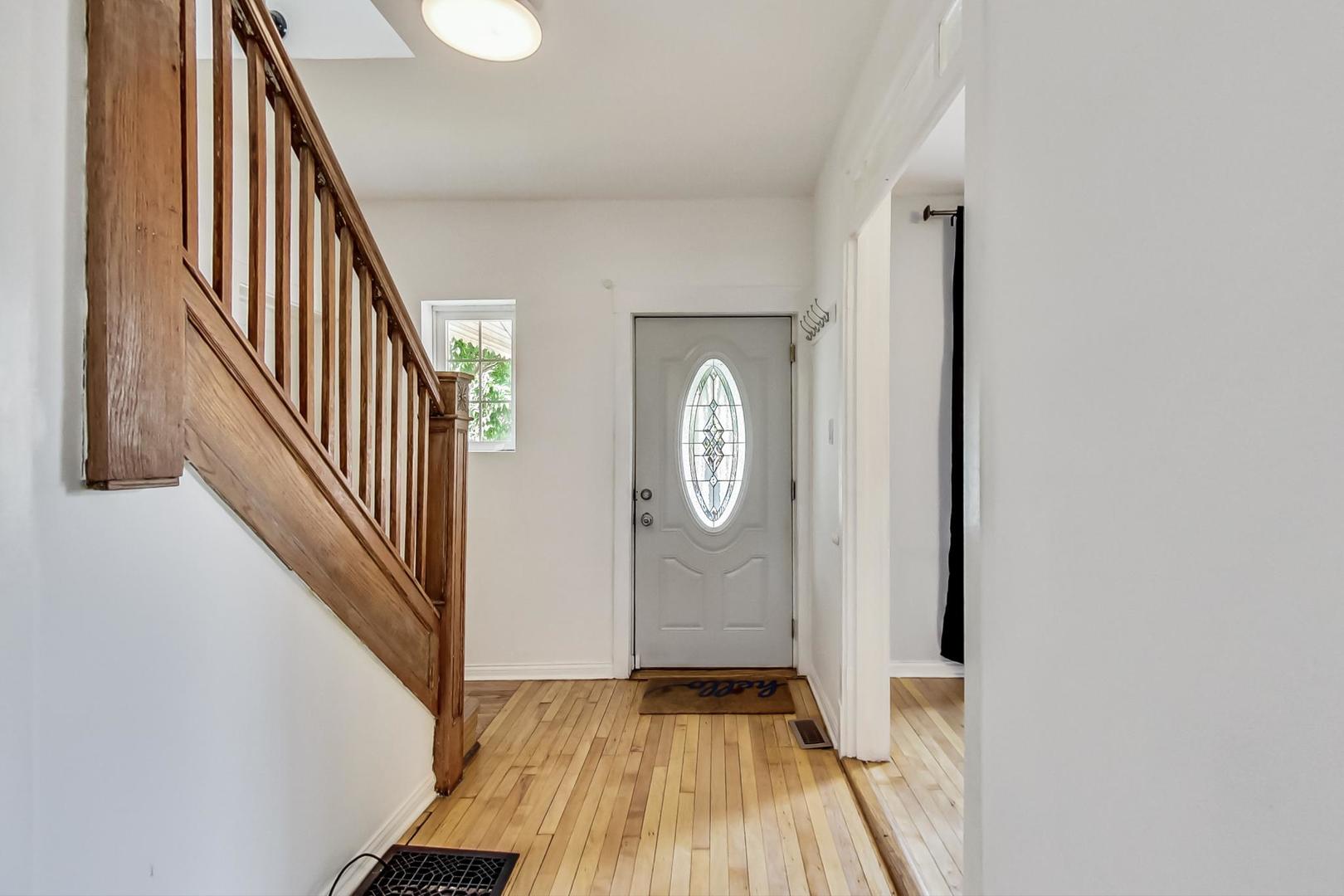 4015 West Addison Street Chicago, IL 60641 - Photo 2 of 30 a view of a hallway with wooden floor and staircase
