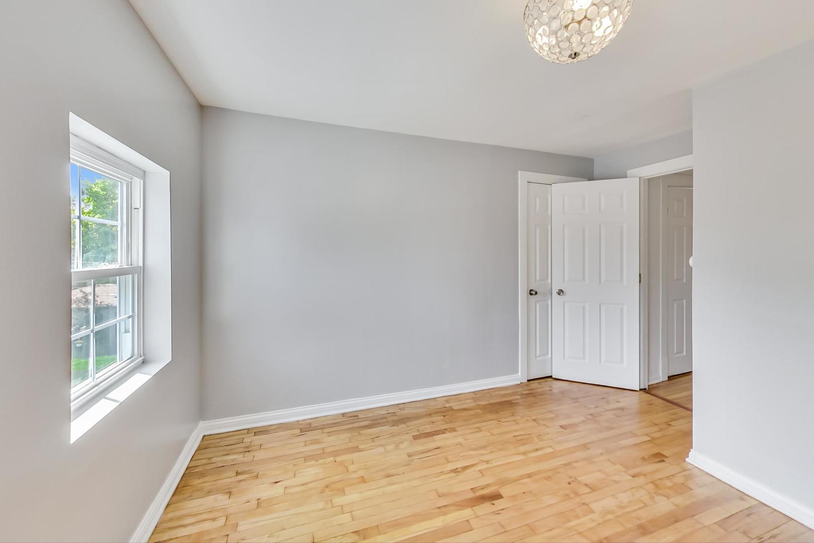 4015 West Addison Street Chicago, IL 60641 - Photo 13 of 30 a view of empty room with wooden floor and fan