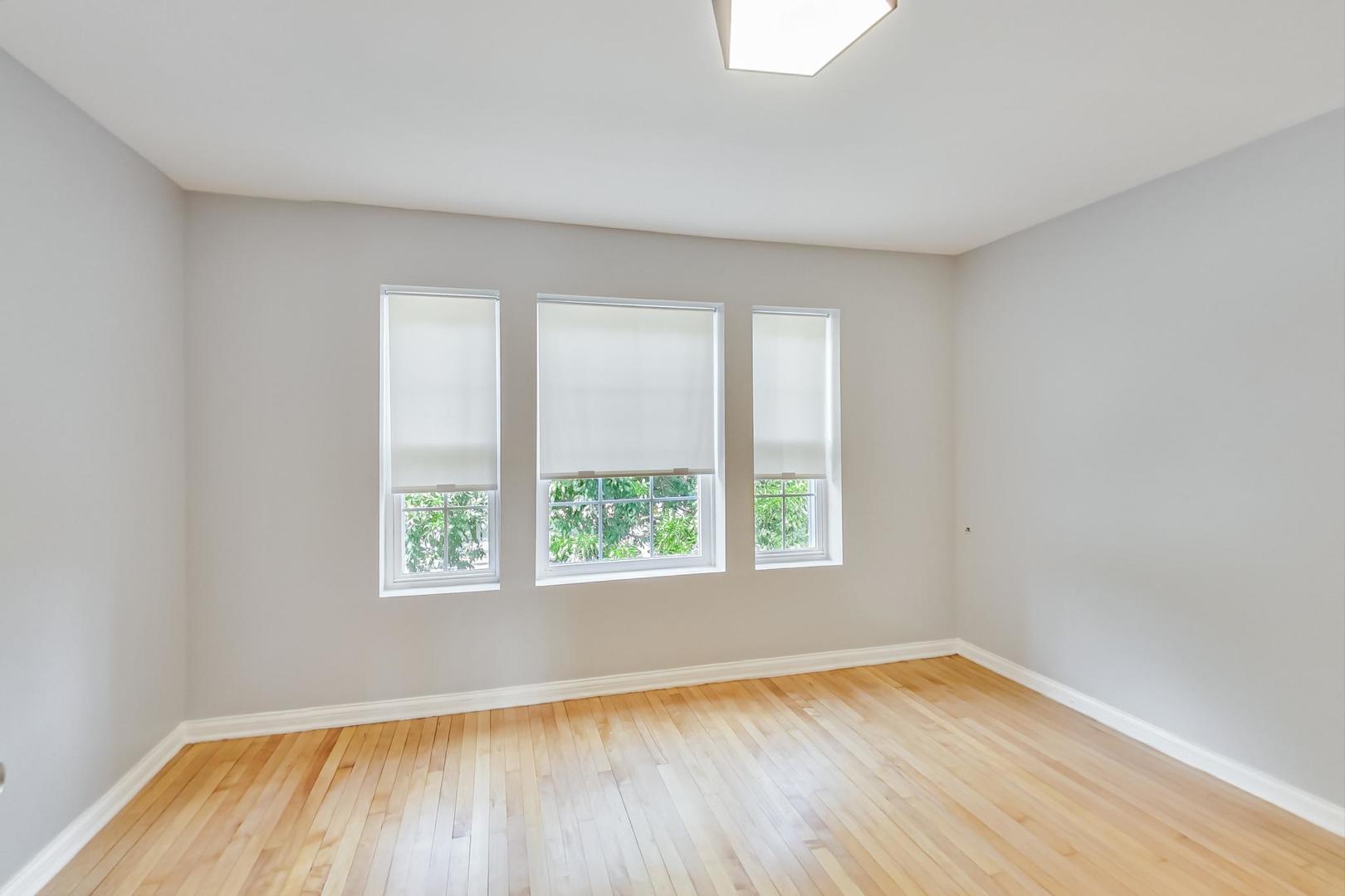 4015 West Addison Street Chicago, IL 60641 - Photo 14 of 30 an empty room with wooden floor and windows