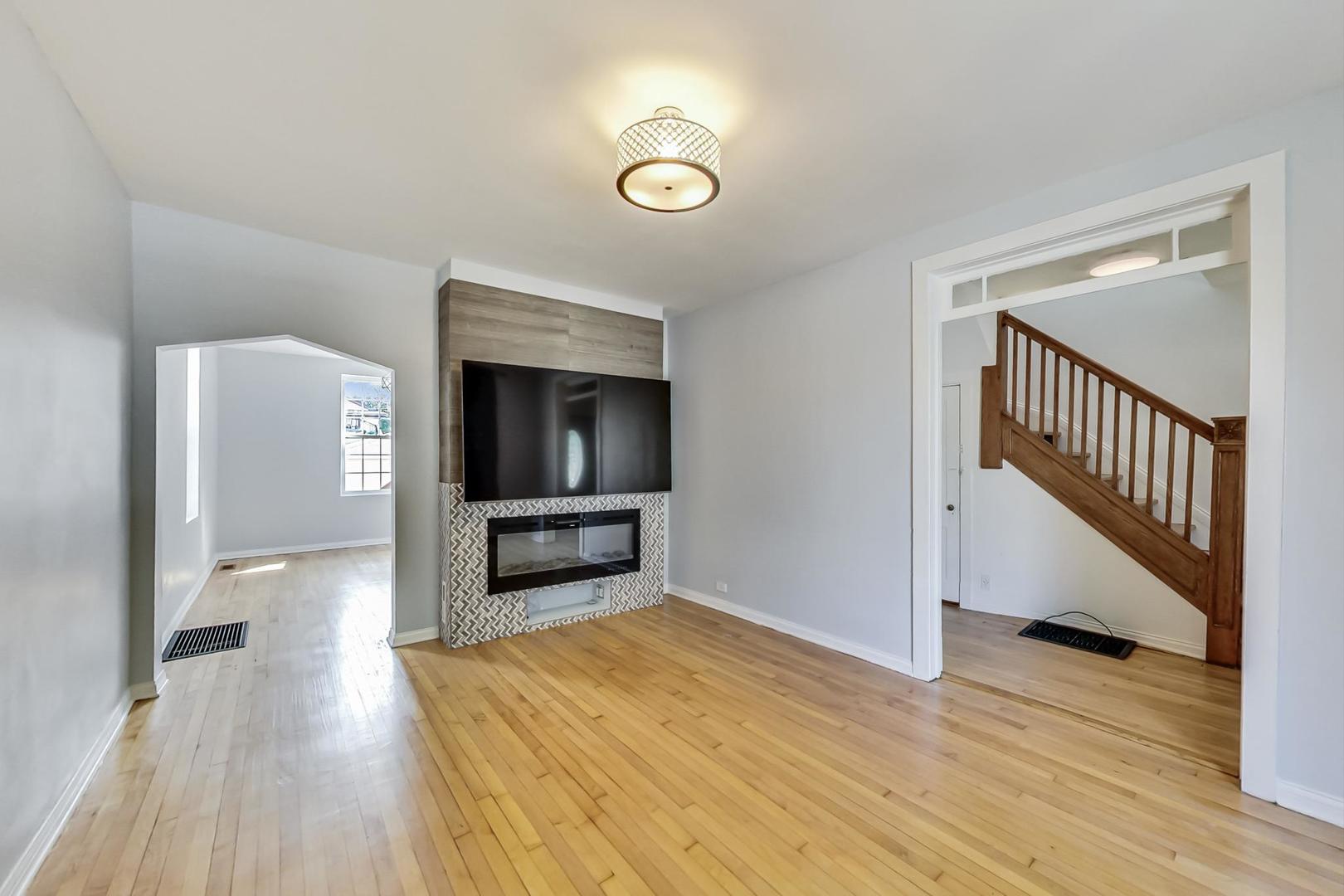4015 West Addison Street Chicago, IL 60641 - Photo 3 of 30 a view of a livingroom with wooden floor