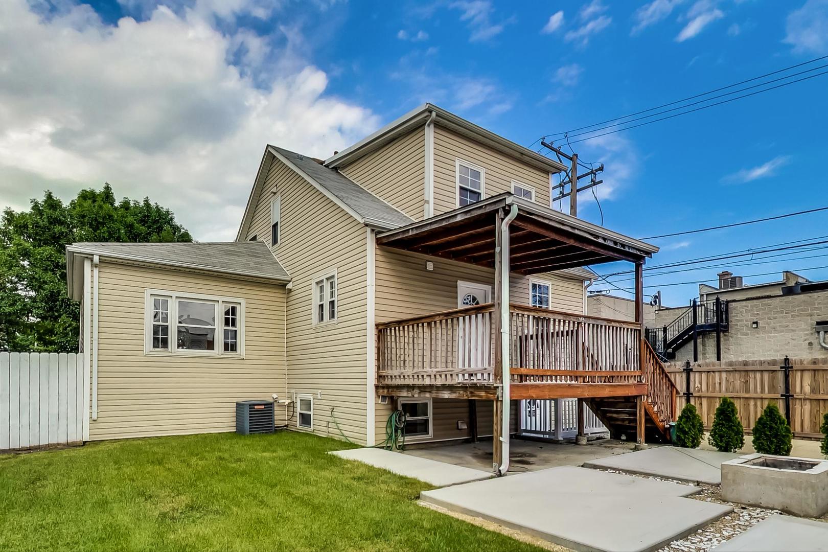 4015 West Addison Street Chicago, IL 60641 - Photo 24 of 30 a view of a house with a yard and deck