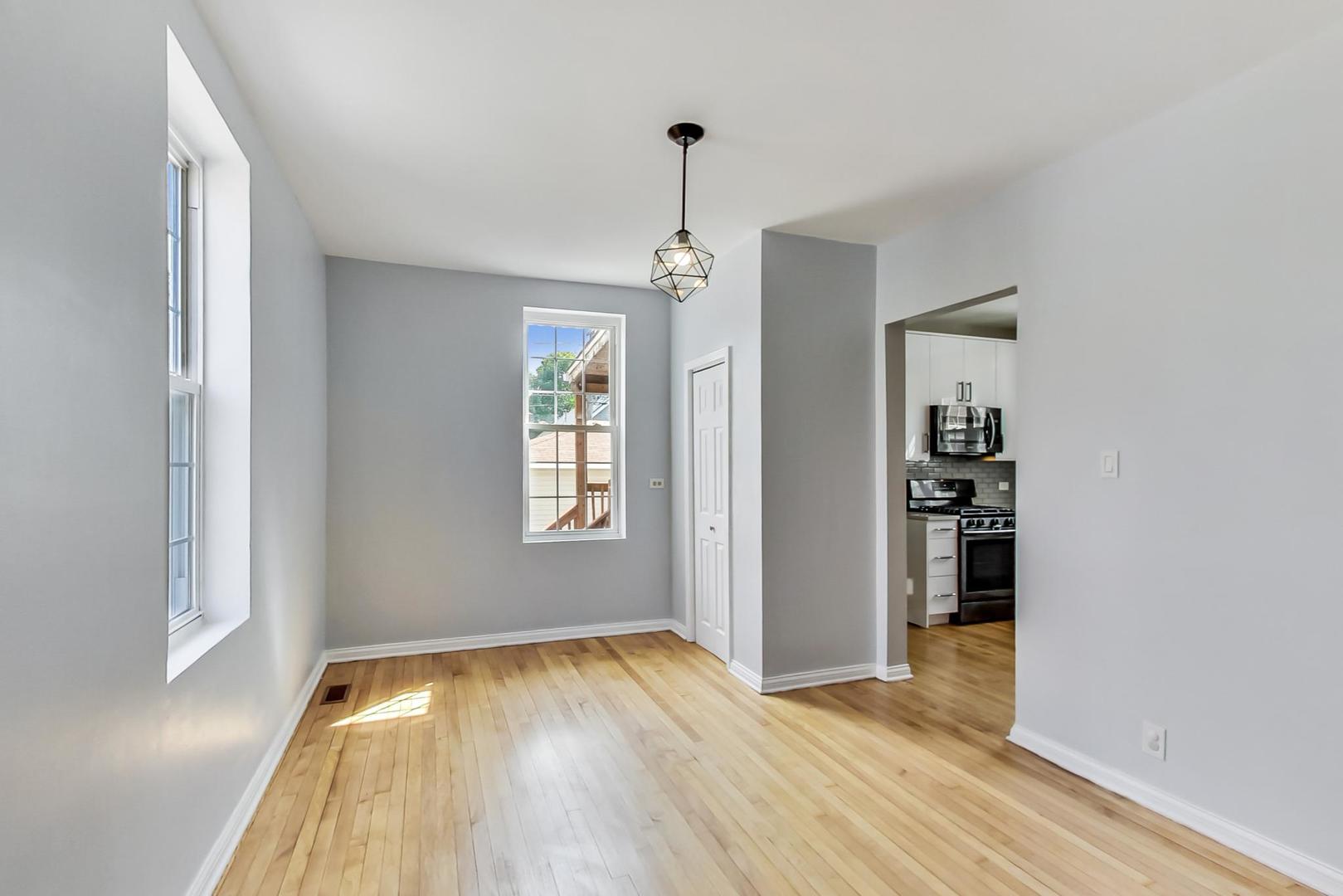 4015 West Addison Street Chicago, IL 60641 - Photo 4 of 30 a view of an empty room with window and wooden floor