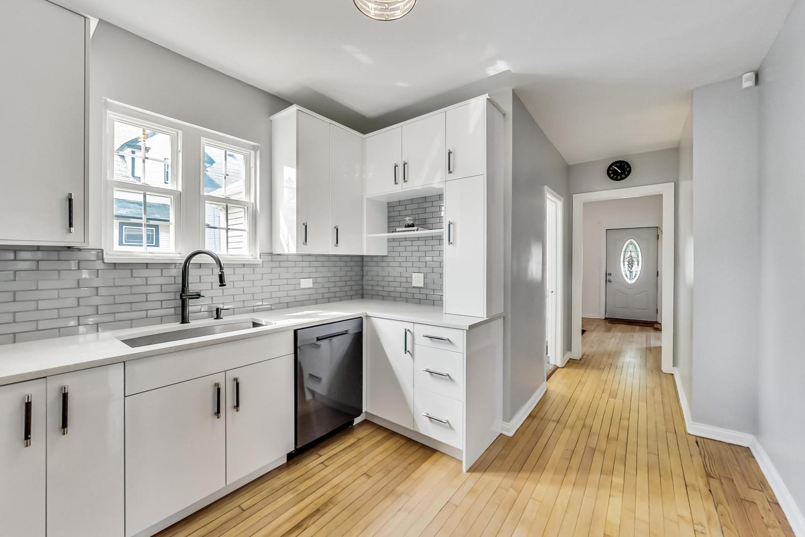 4015 West Addison Street Chicago, IL 60641 - Photo 7 of 30 a view of a kitchen with a sink and wooden floor