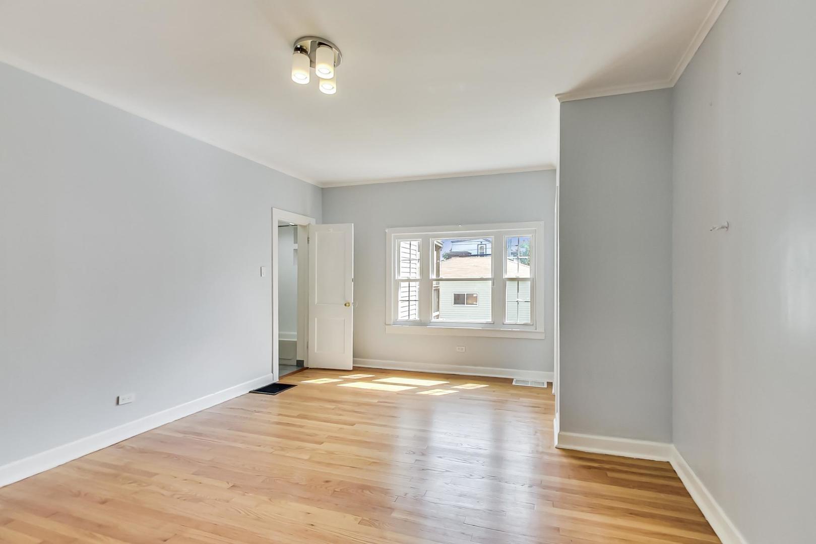 4015 West Addison Street Chicago, IL 60641 - Photo 8 of 30 an empty room with wooden floor and windows