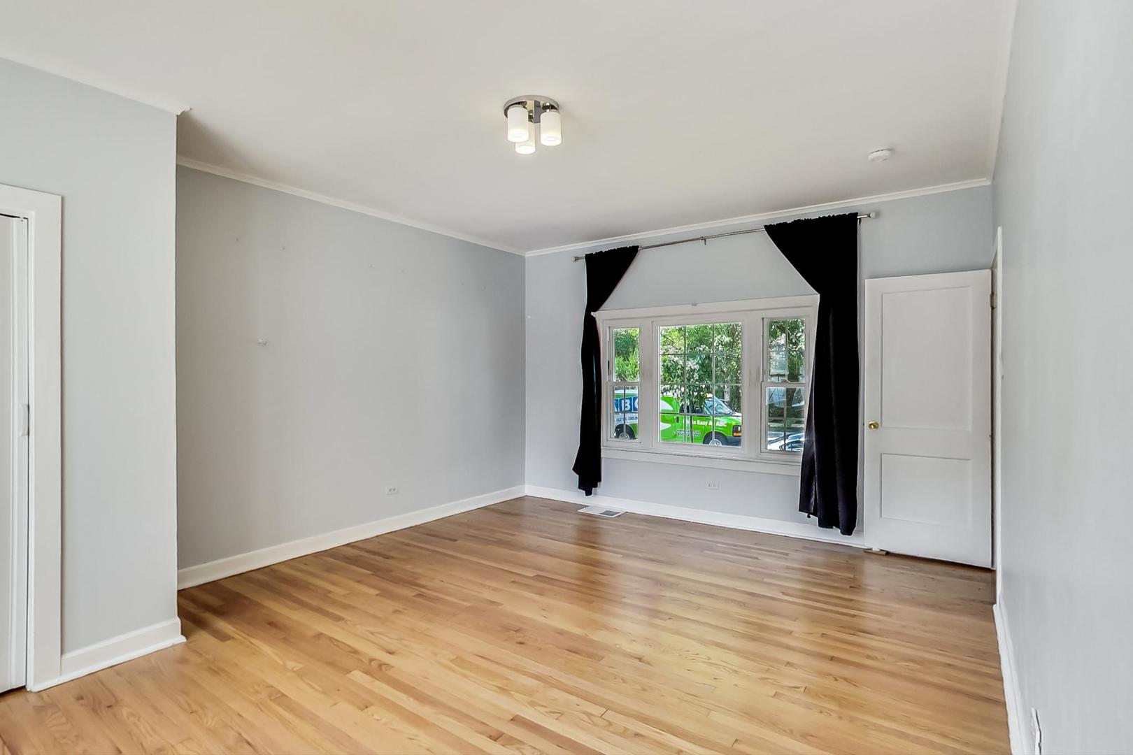 4015 West Addison Street Chicago, IL 60641 - Photo 9 of 30 a view of empty room with wooden floor and fan