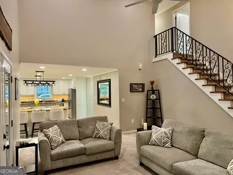 a living room with furniture and a kitchen view