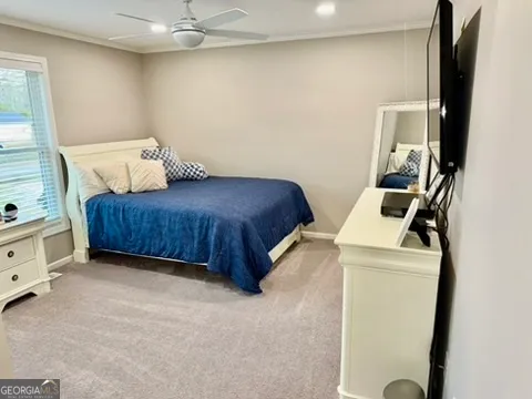 a view of staircase with lots of frames on wall and a window