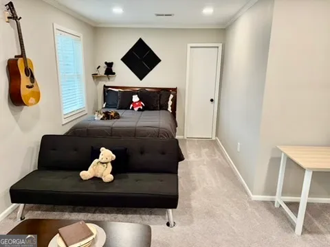a living room with furniture a flat screen tv and kitchen view