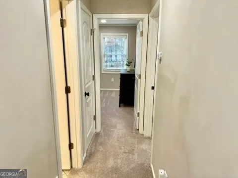 a large bed sitting in a bedroom next to a window