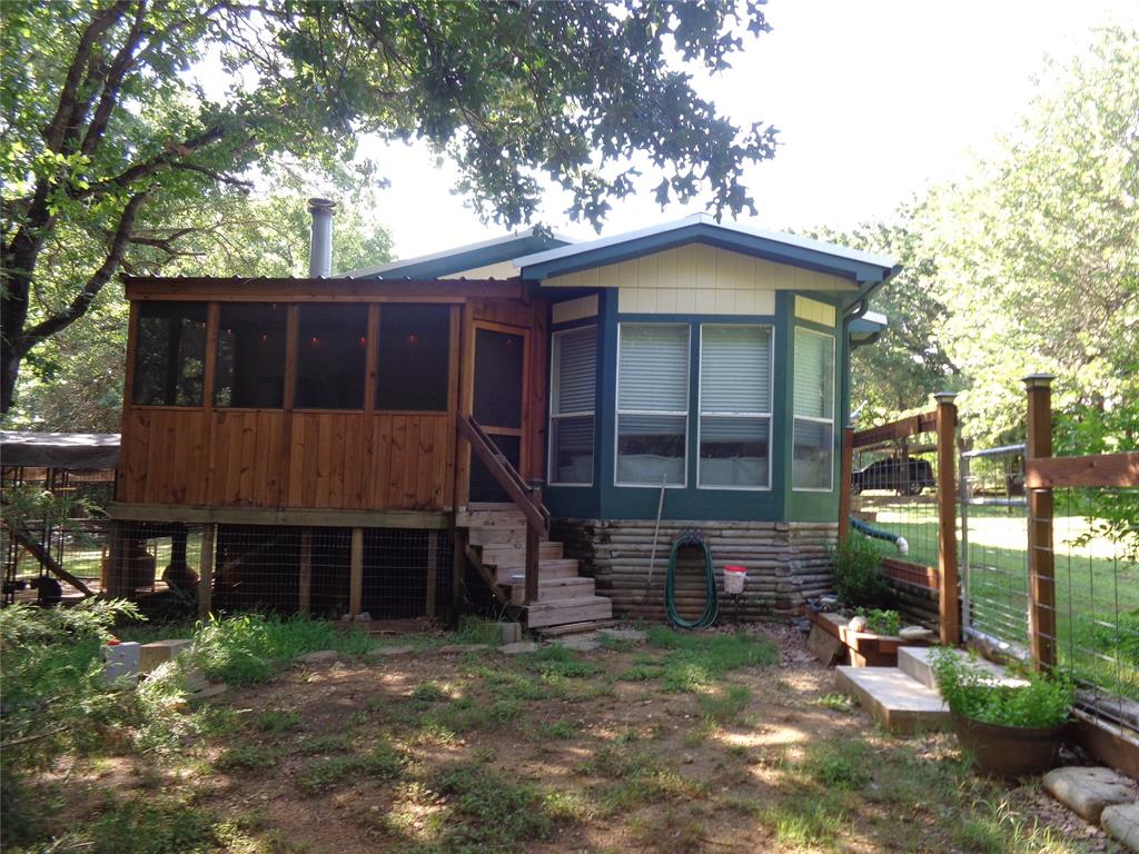 5525 Cedar Oaks Road Grandview, TX 76050 - Photo 11 of 18 Wood-sided screened porch and exterior stairs