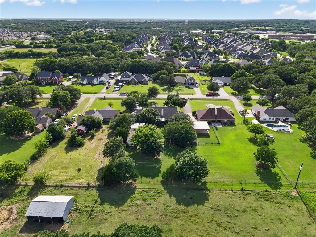 421 Ben Boyd Road Argyle, TX 76226 - Photo 21 of 25 Expansive lot featuring a large green space, mature trees, and a distant neighborhood