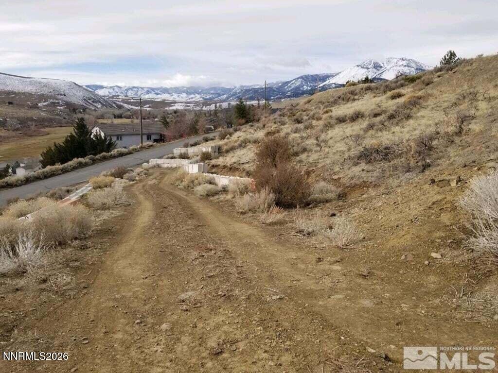 20475 Temelec Way Reno, NV 89521 - Photo 2 of 3 a view of a dry yard with mountains in the background