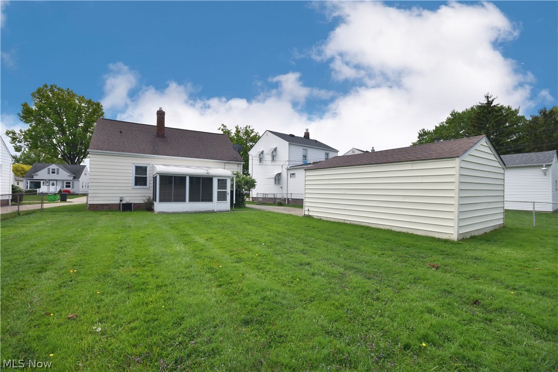 31921 Pendley Road Willowick, OH 44095 - Photo 22 of 22 Rear view of house featuring an enclosed porch, fenced in yard