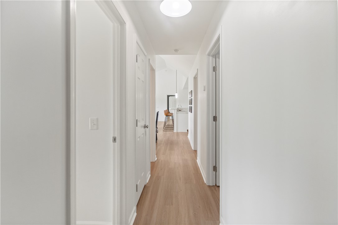 2900 Highway 187 Anderson, SC 29626 - Photo 20 of 41 A well-lit hallway with light wood flooring leads to a spacious, open living area.