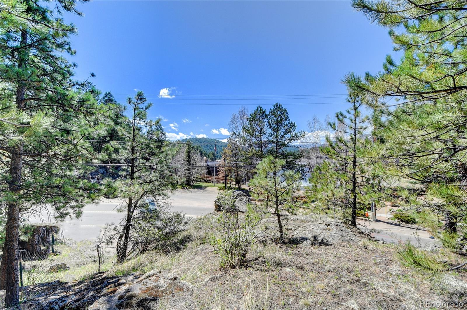 4690 Highway 73 Evergreen Co 80439 Evergreen, CO 80439 - Photo 17 of 34 a view of backyard of house with outdoor seating
