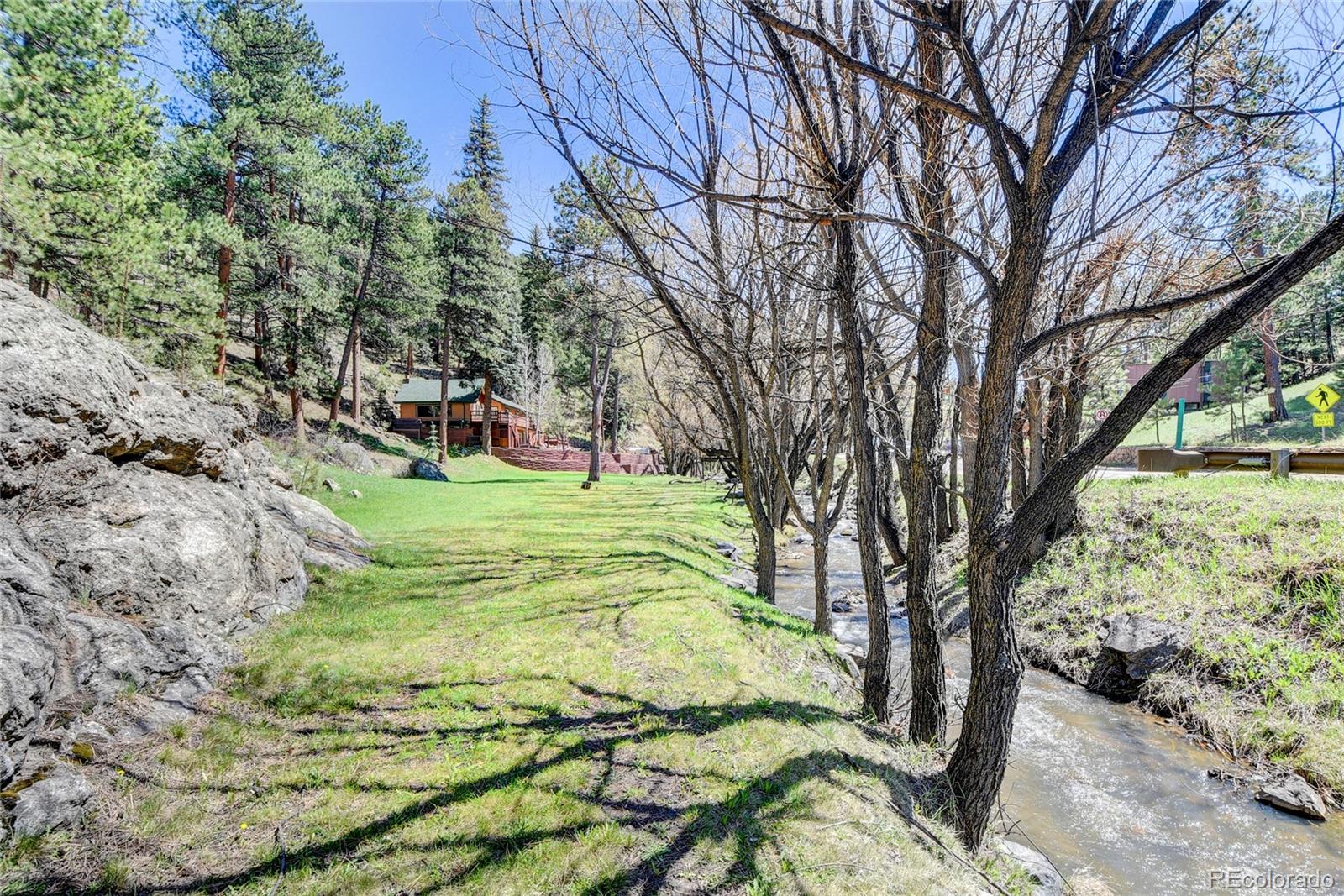 4690 Highway 73 Evergreen Co 80439 Evergreen, CO 80439 - Photo 26 of 34 a view of a yard with plants and large trees