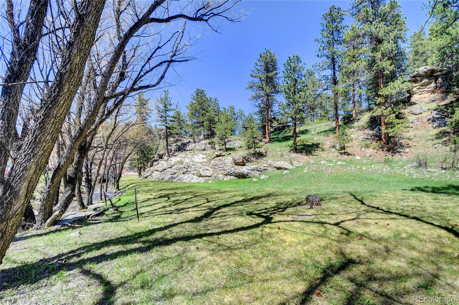 4690 Highway 73 Evergreen Co 80439 Evergreen, CO 80439 - Photo 27 of 34 a backyard of a house with a yard and outdoor seating