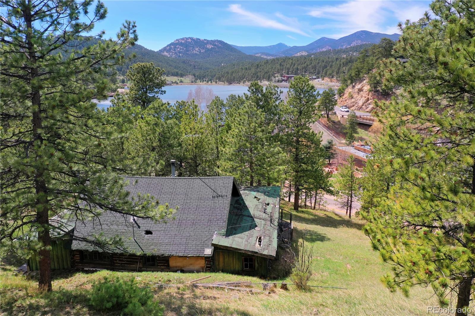 4690 Highway 73 Evergreen Co 80439 Evergreen, CO 80439 - Photo 9 of 34 an aerial view of a house with a yard and mountain view