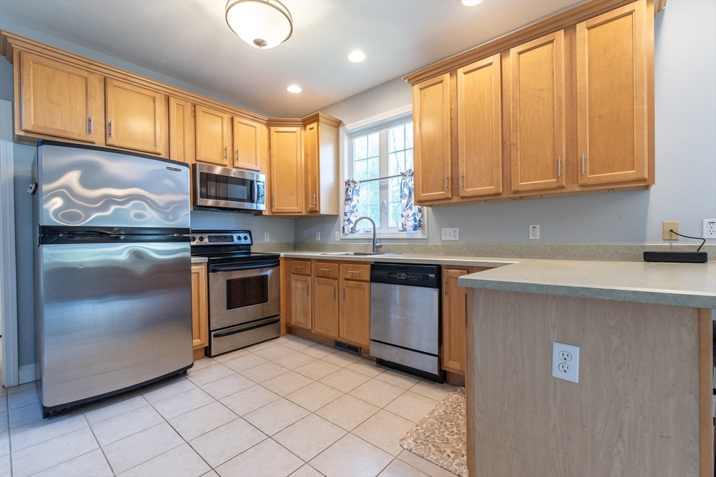 7 Buffy Road Bellingham, MA 02019 - Photo 5 of 34 a kitchen with stainless steel appliances granite countertop a stove a sink and a microwave