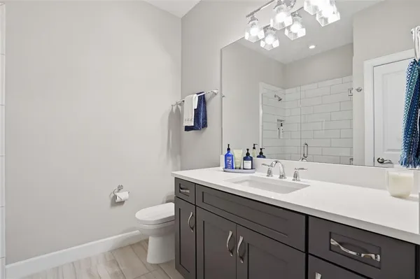 a living room with furniture a chandelier and a dining table