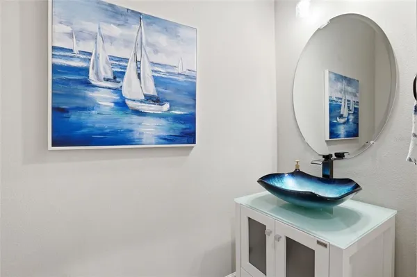 a living room with furniture a fireplace and a chandelier