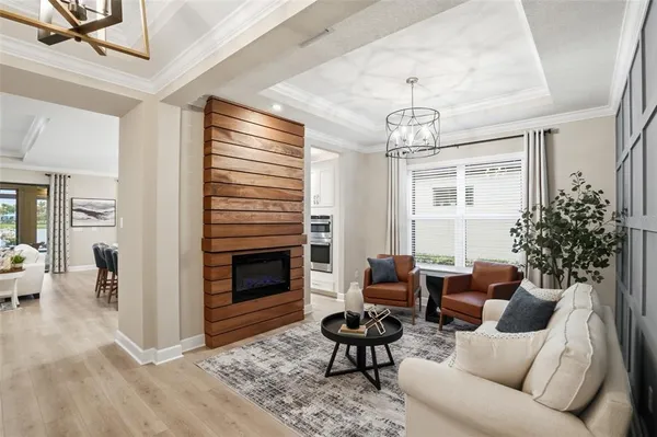 a living room with furniture a large window and a flat screen tv
