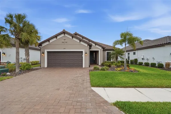 a front view of a house with a garden and yard