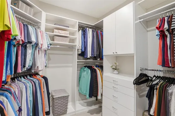 a view of a lake with a table and chairs next to a yard