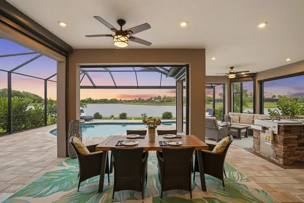 a view of a patio with table and chairs under an umbrella