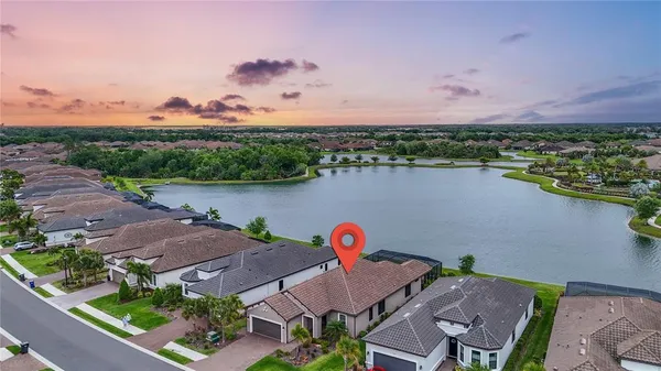 a view of a dining room with furniture wooden floor and chandelier