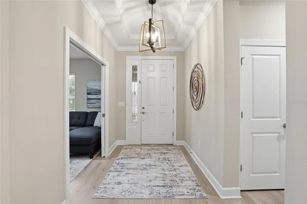 a view of a hallway with entryway wooden floor and front door